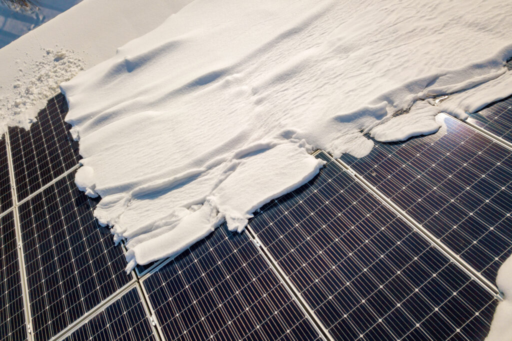 Solar panels covered in snow illustrating winter energy production.
