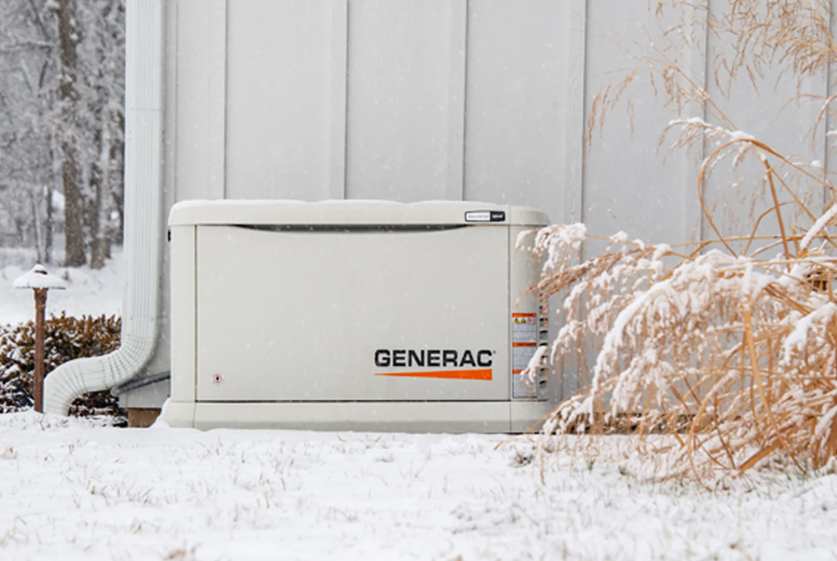 Whole-home standby generator in snow providing backup power during outages.