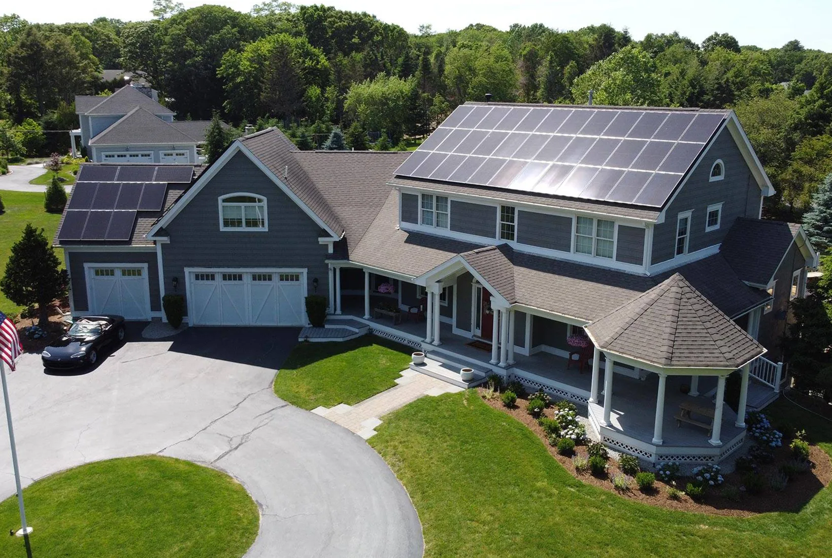Residential home with solar panels and EV charger, showcasing rooftop solar installation.