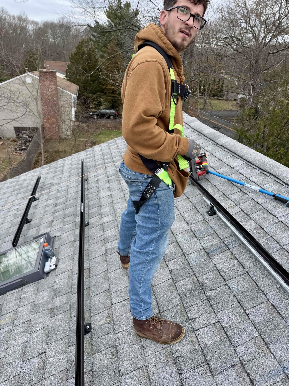 Rooftop Power installer servicing a solar system on the roof