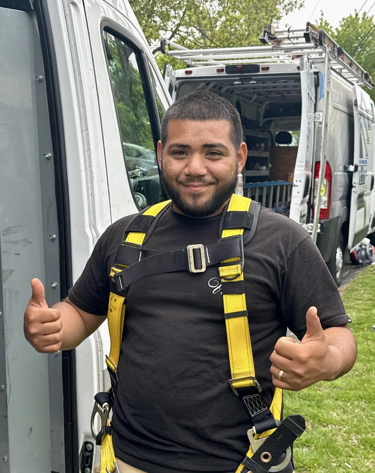 Rooftop Power technician giving thumbs-up, servicing solar systems and orphaned installations.