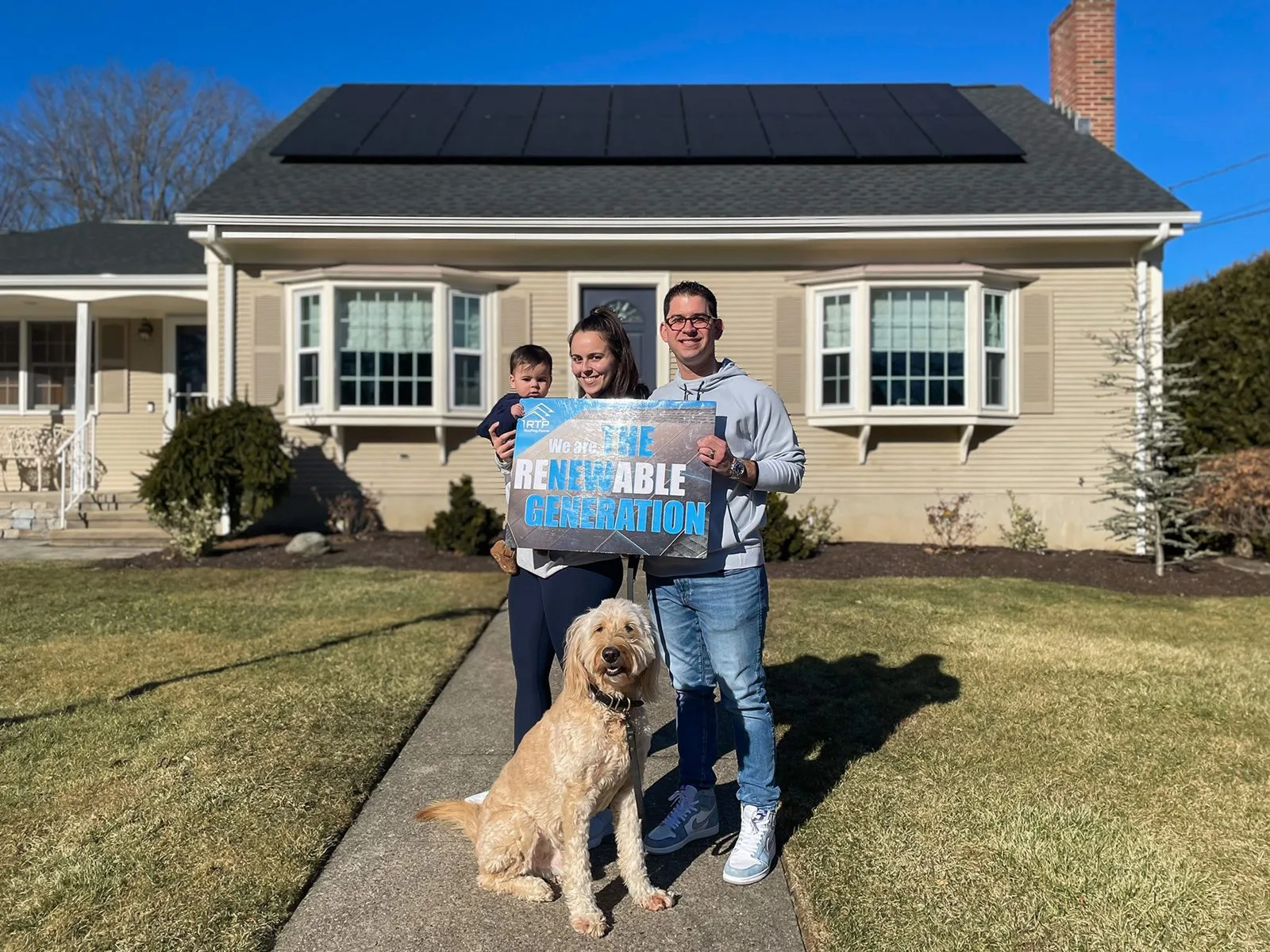 Johnston, Rhode Island homeowner and family with dog, showcasing Rooftop Power solar panel installation.