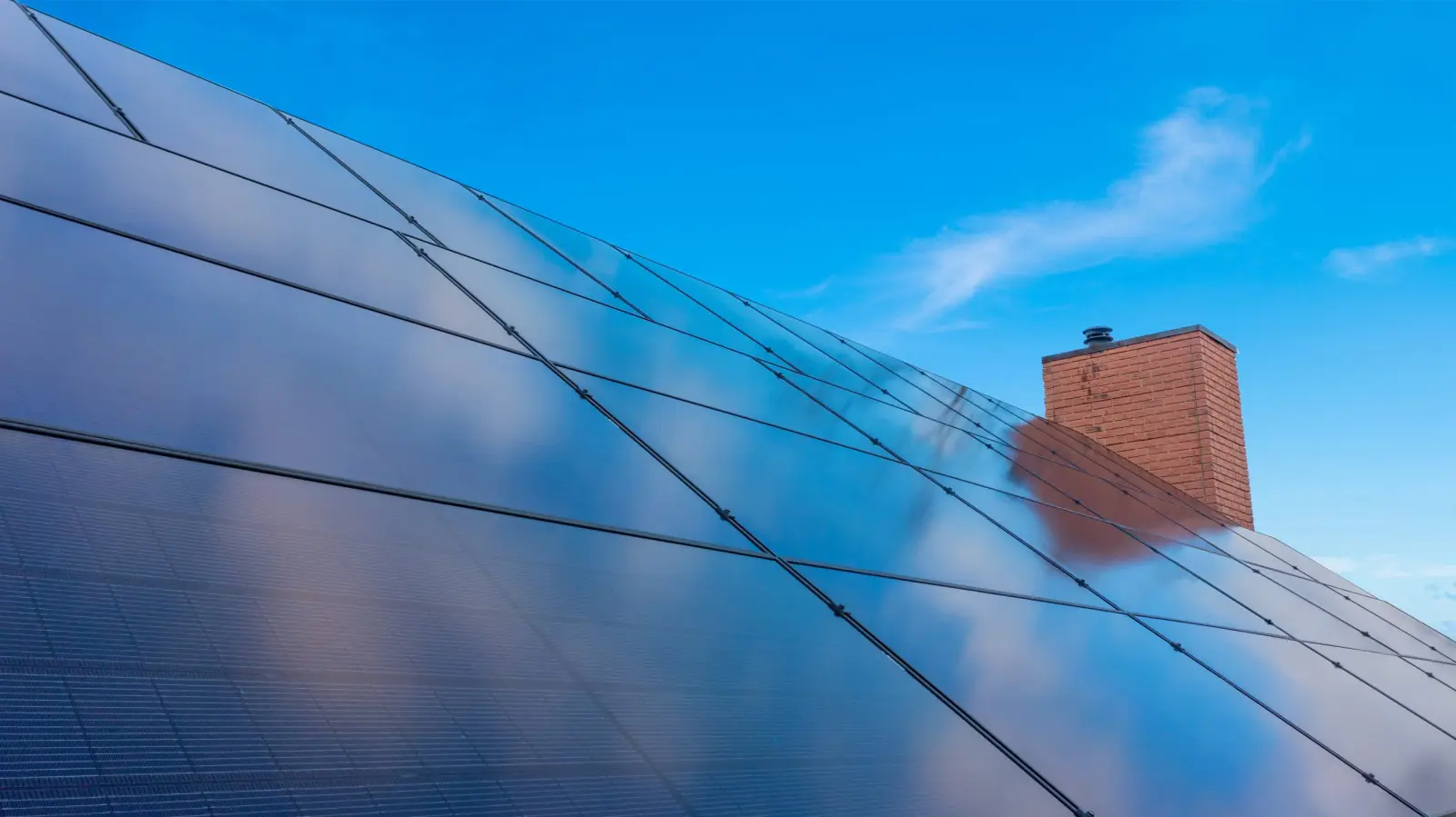 Rooftop solar array installation in South Kingstown, Rhode Island, with completed solar panel system and chimney.