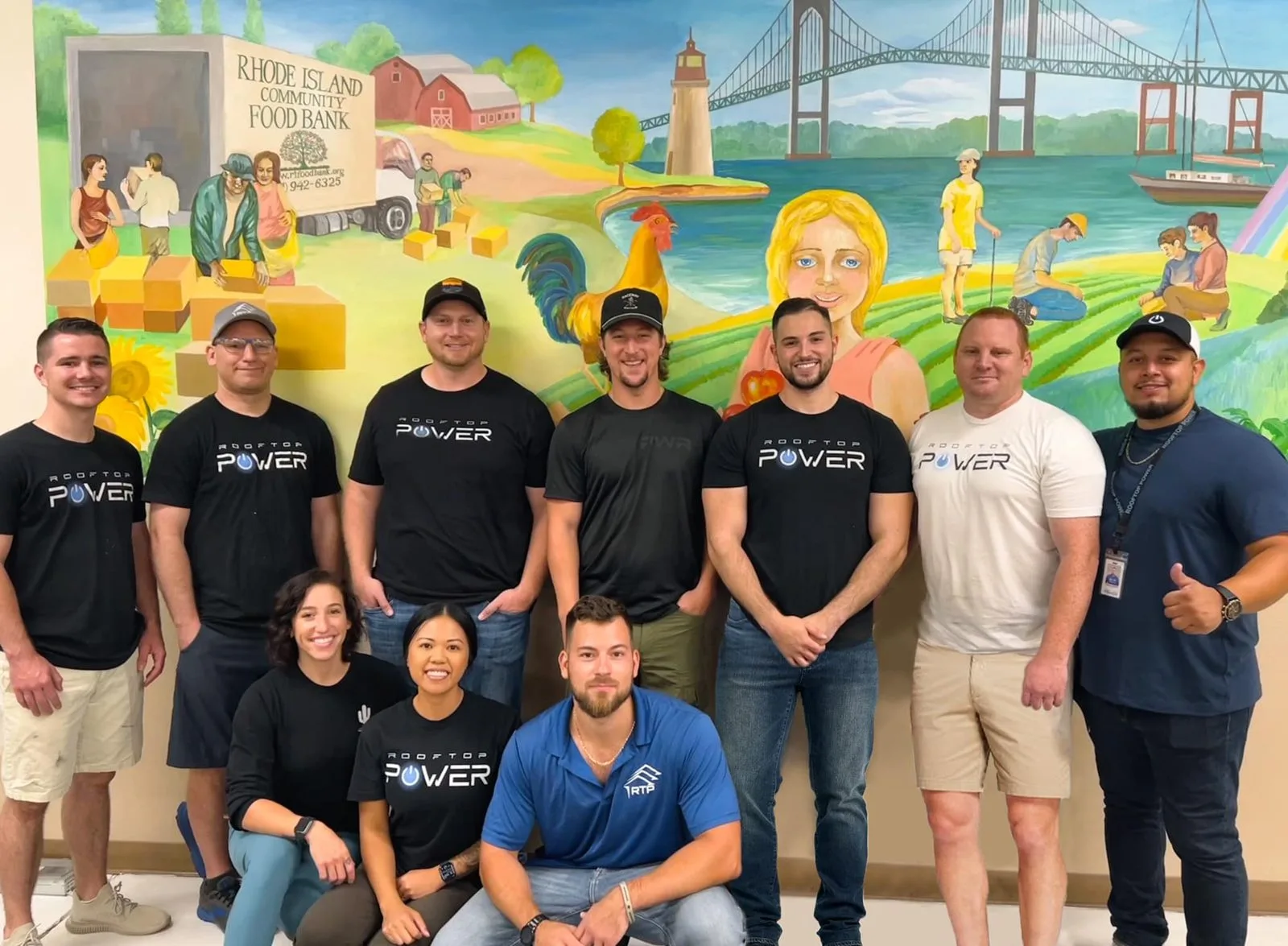Rooftop Power team volunteering at Rhode Island Community Food Bank, supporting local communities.