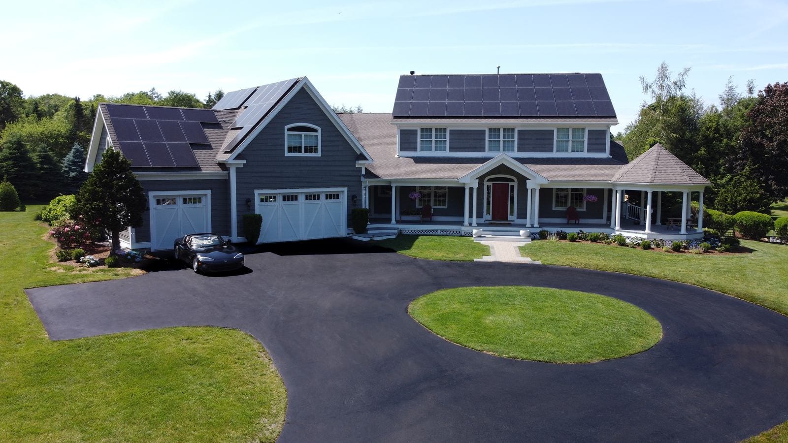 Residential solar panel installation on colonial home, Rhode Island Renewable Energy Growth program incentives.