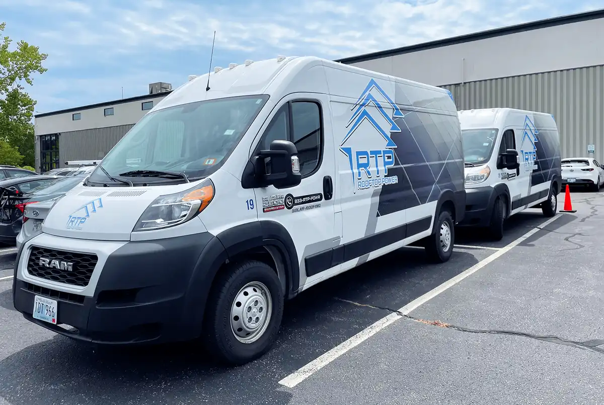Rooftop Power service vans parked with installation crews